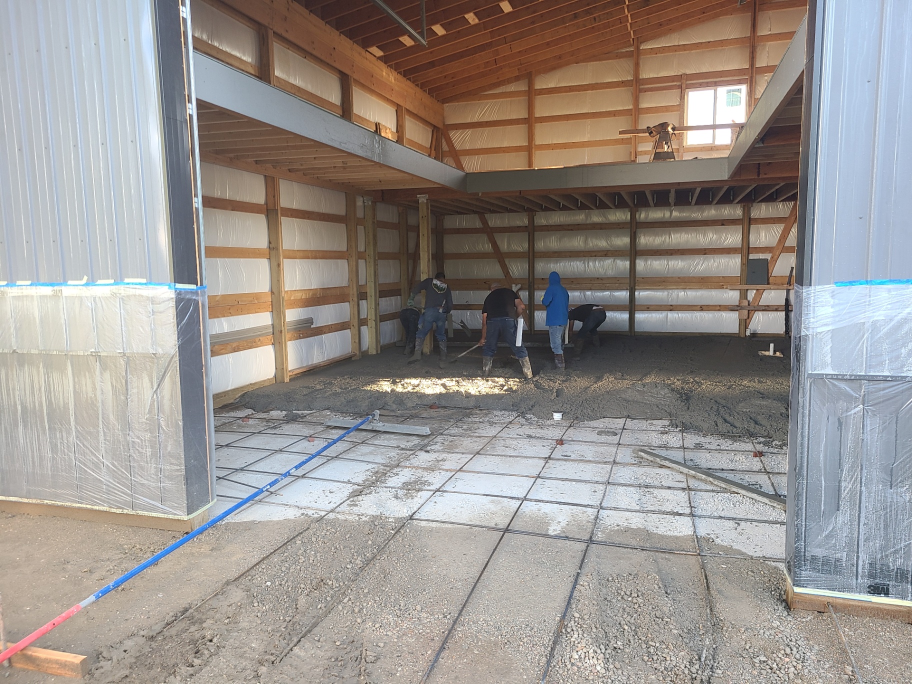 Rebar grid set in a pole barn floor pour