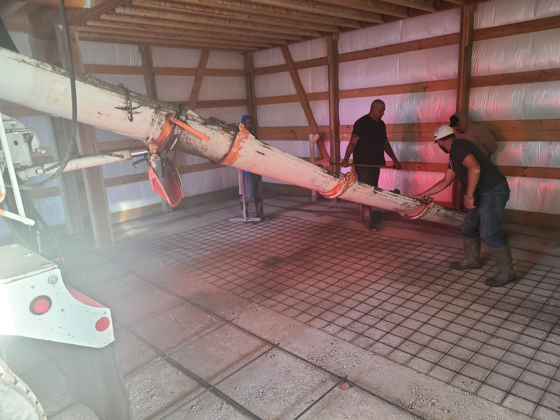 Concrete pump truck pouring a barn floor
