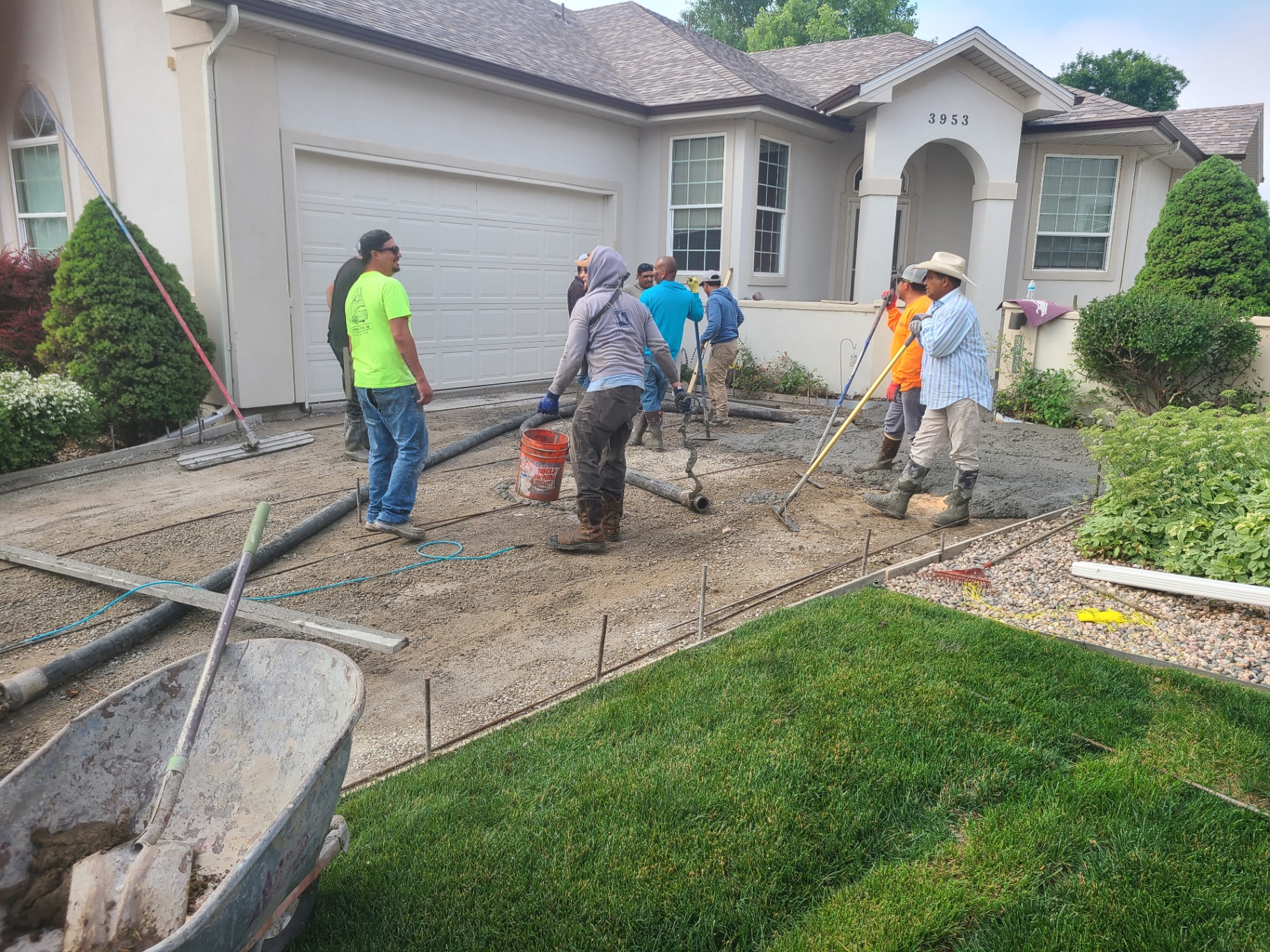 Crew screeding a new driveway slab