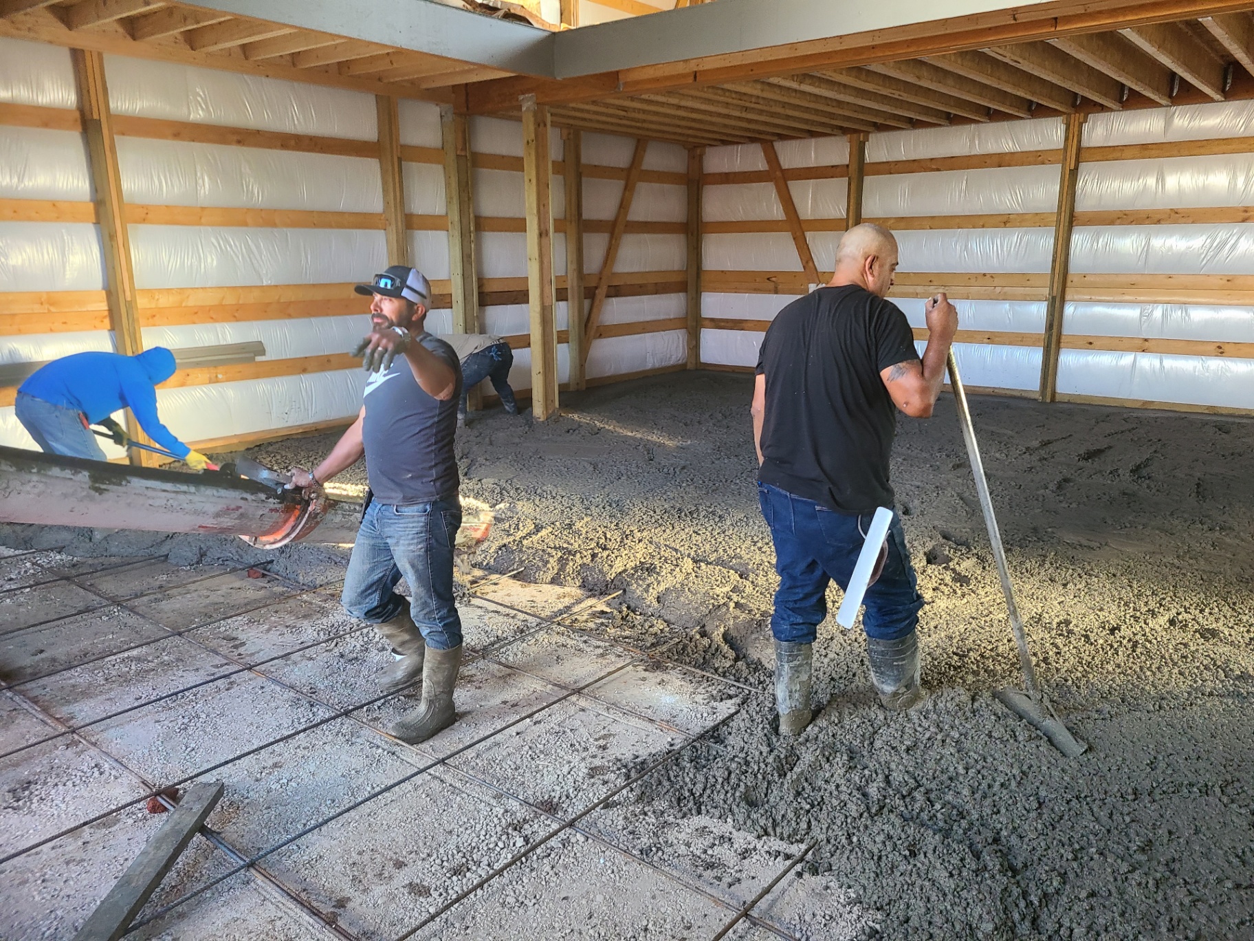 Crew finishing a pole barn interior slab